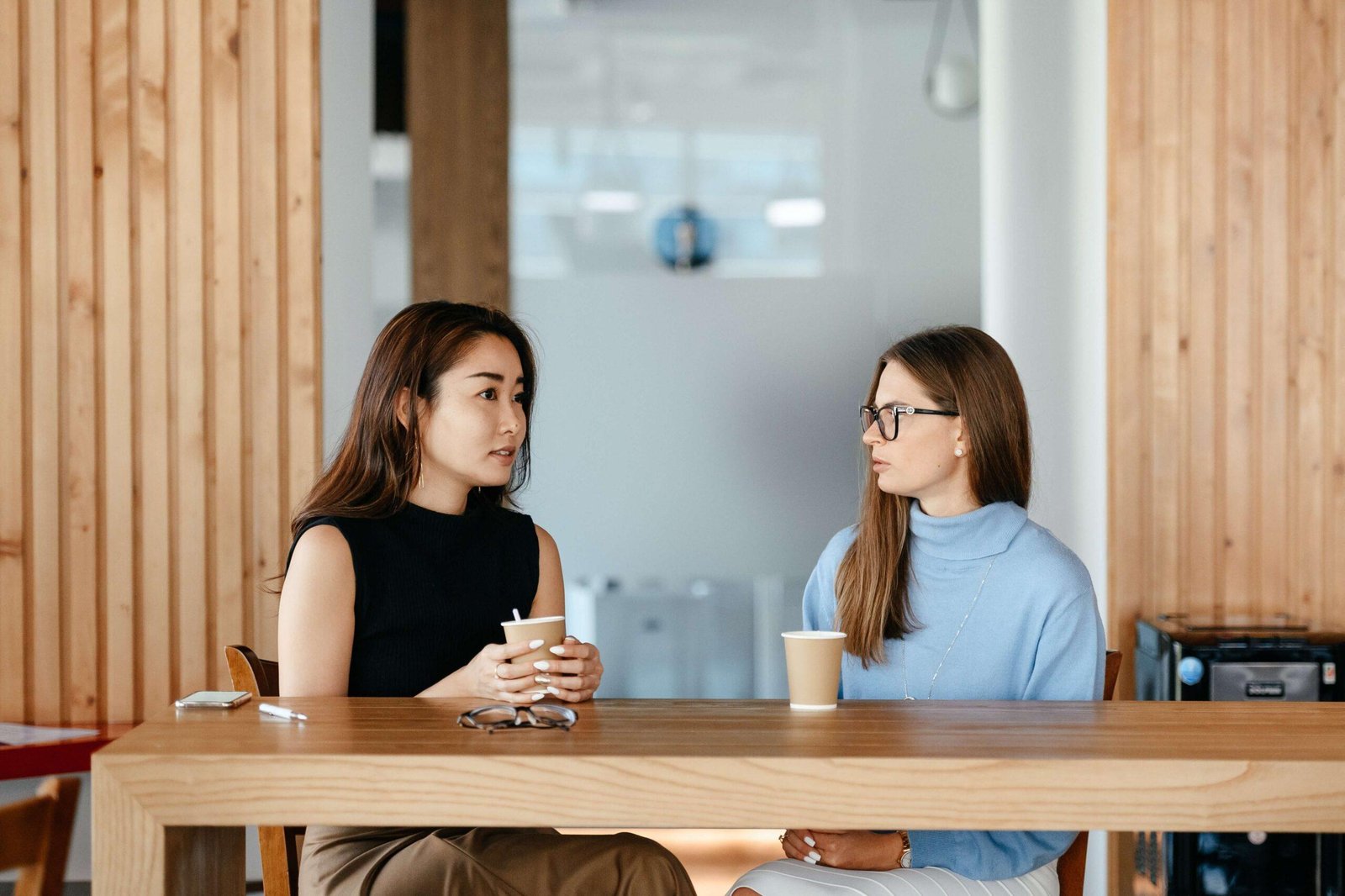 Two women in a discussion practising active listening.