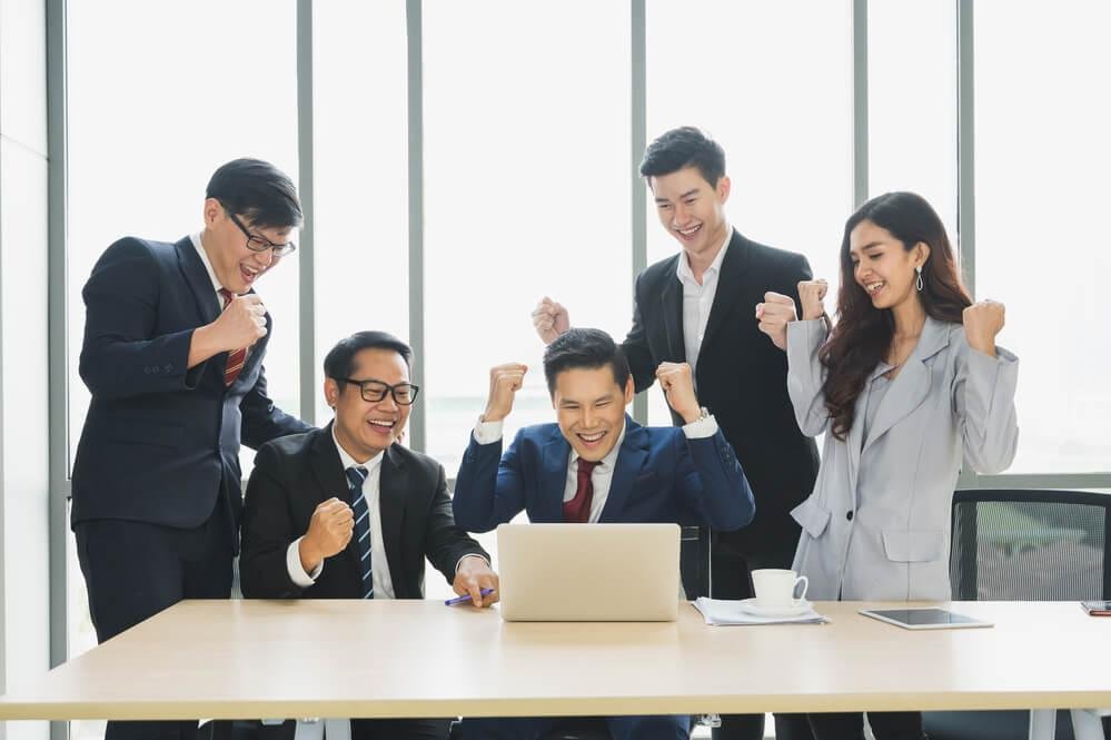 Leader celebrating successful strategic focus with team, emphasizing productivity and leadership success.