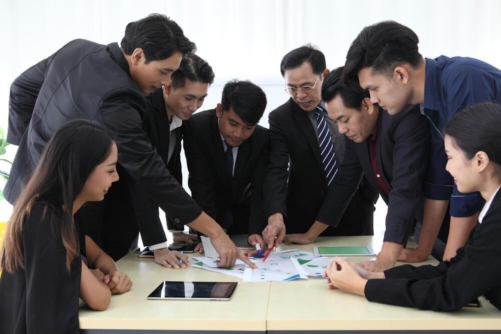 Leaders in a strategic meeting, focusing on decision-making and balancing organizational priorities.